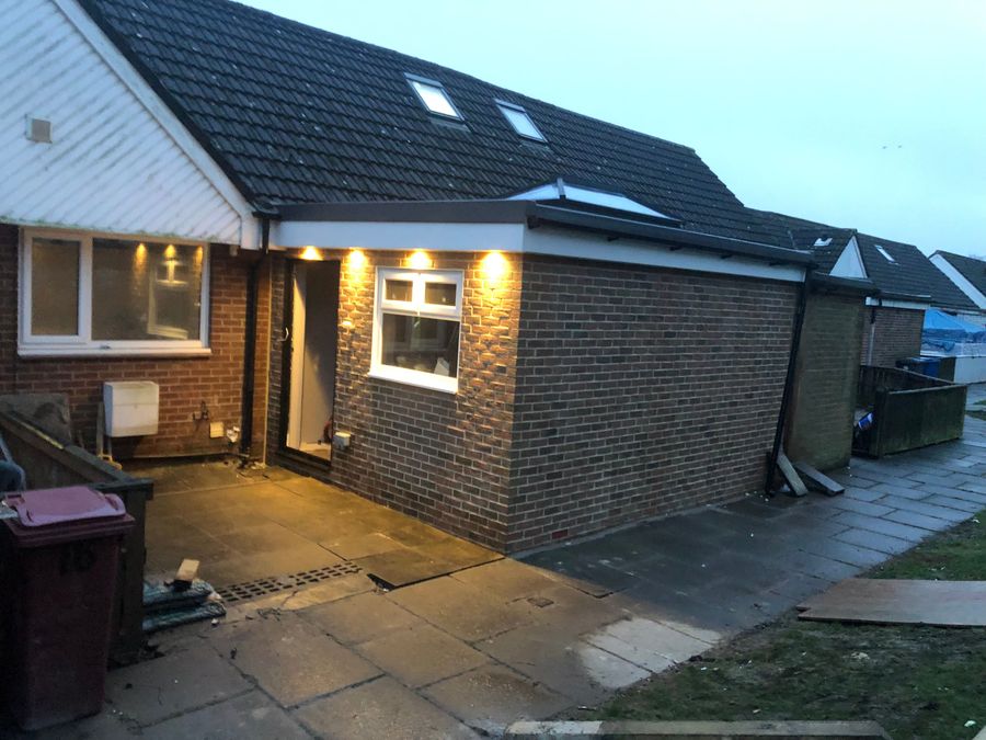 Brick side extension with rooflight photographed at dusk
