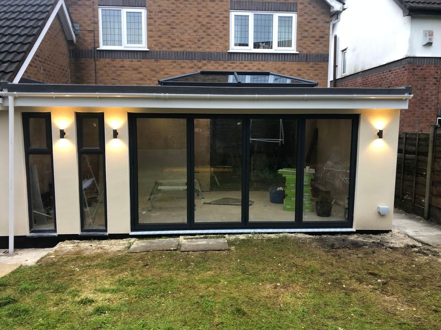 Rendered rear extension with bifold doors and downlights on a semi-detached house