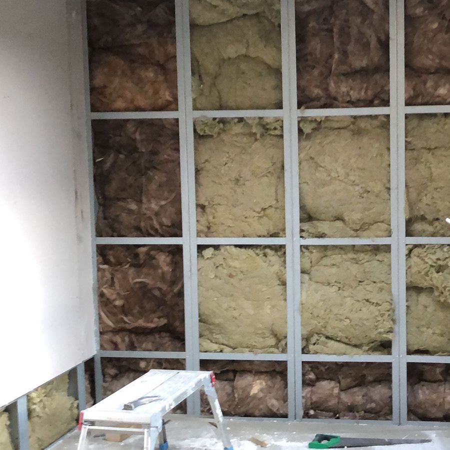 Insulation being fitted inside a modular wall panel during factory build