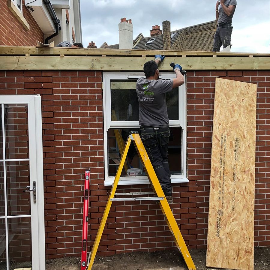 Installer fitting a window into the modular extension frame