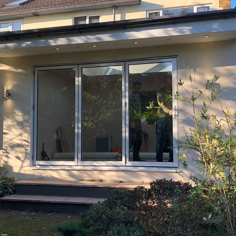 Finished modular extension exterior with grey sliding patio doors